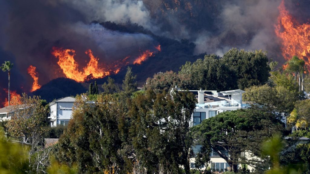 Wildfires rage in Los Angeles, forcing tens of thousands to flee